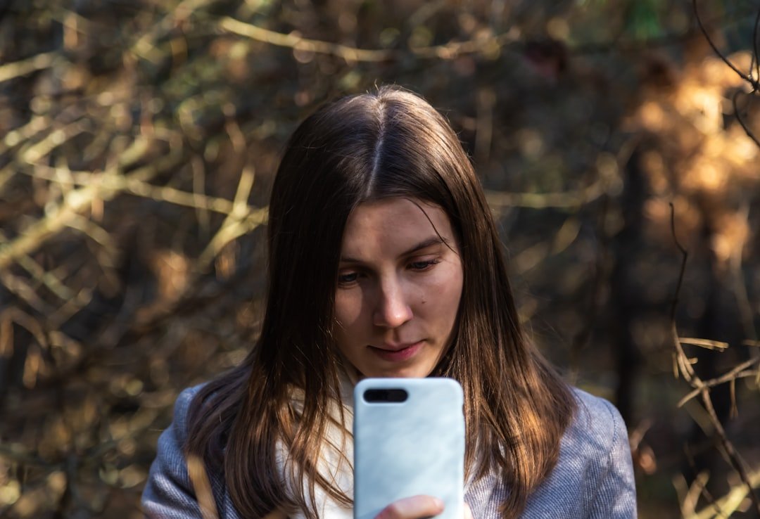 woman looking at smartphone alone