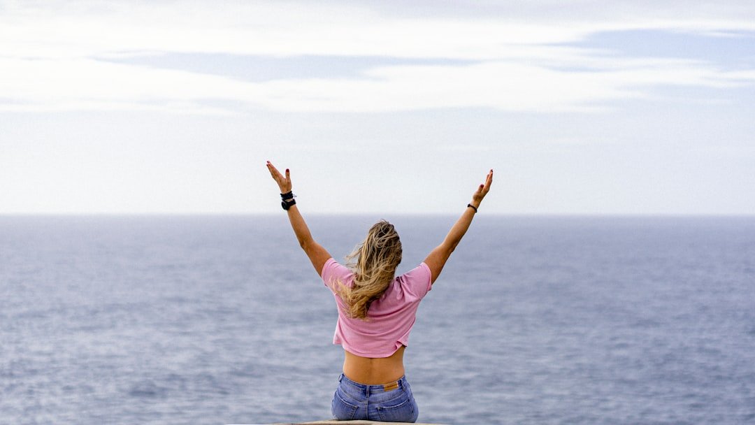 woman arms raised achievement