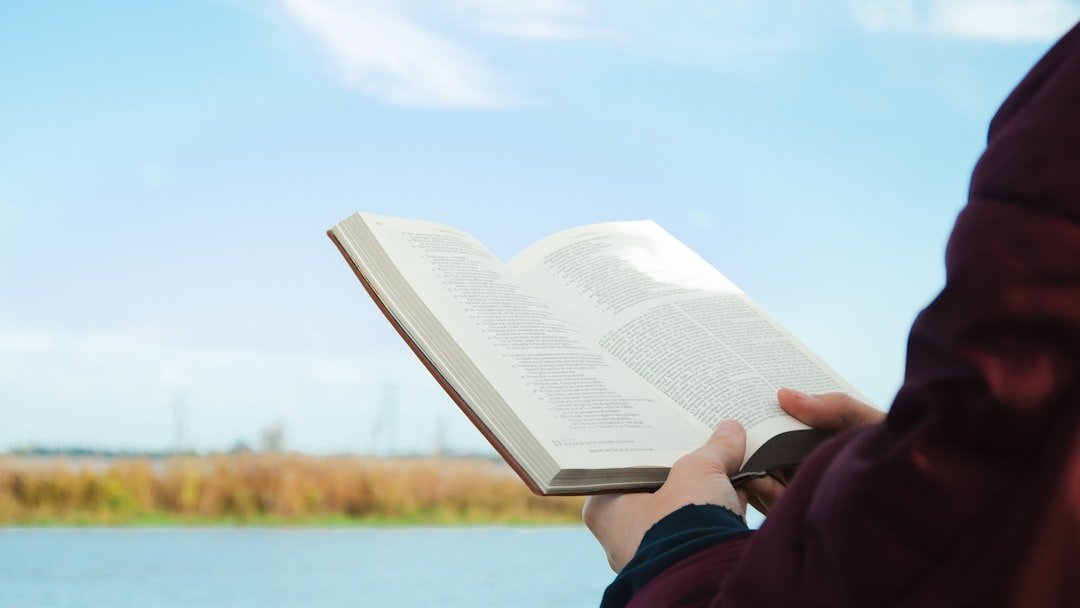 person reading book nature outdoor