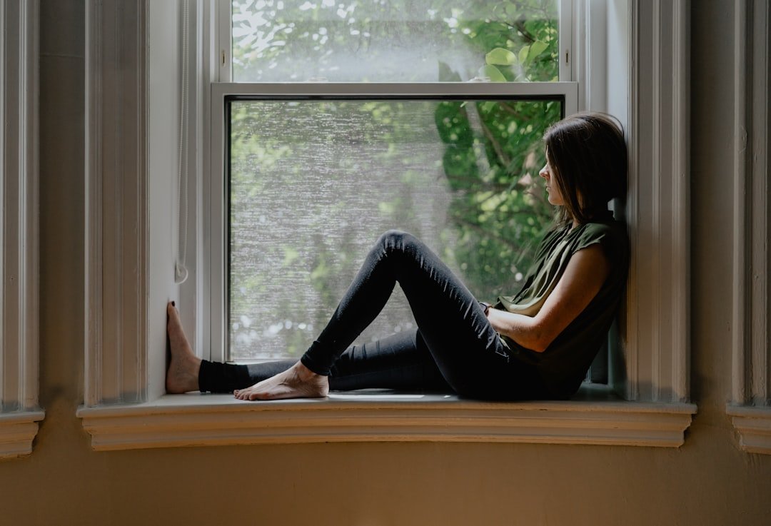 woman sitting alone window