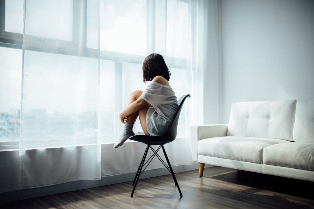 woman alone window thoughtful