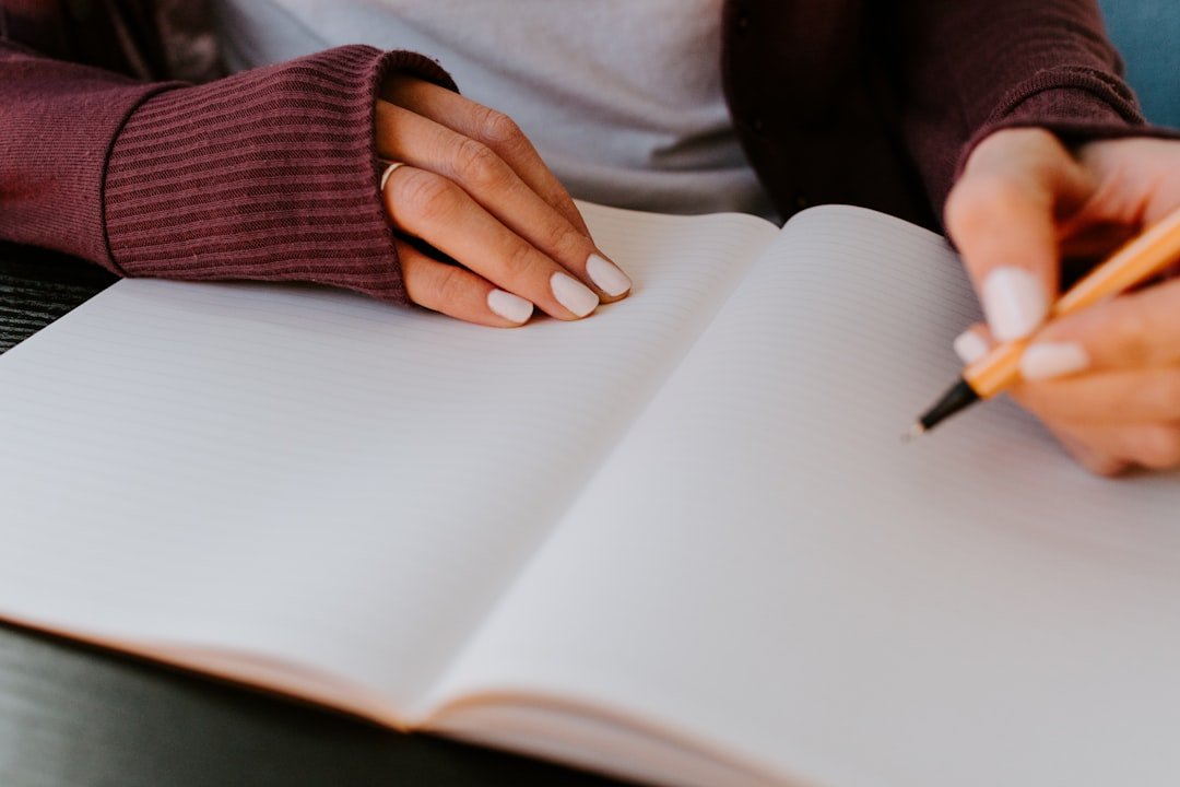 person writing journal notebook
