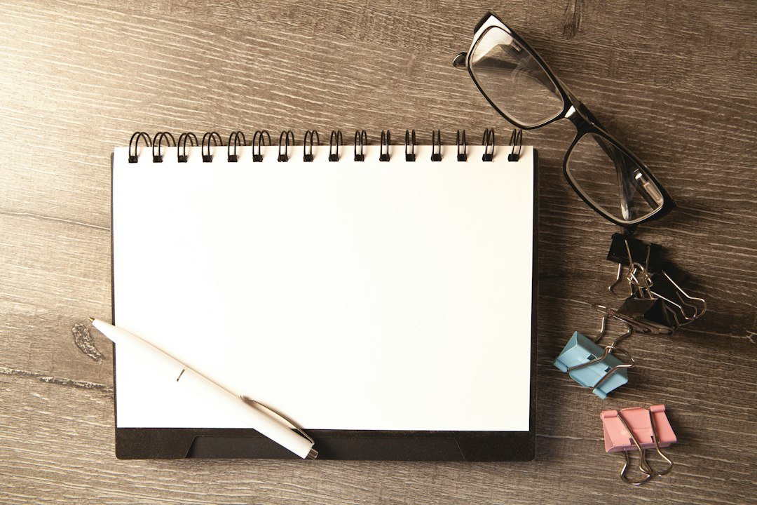 open notebook pen wooden desk
