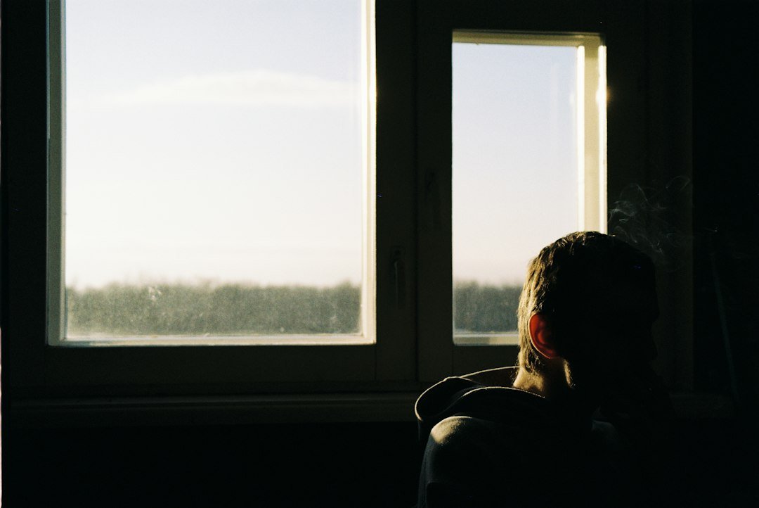 person sitting alone window